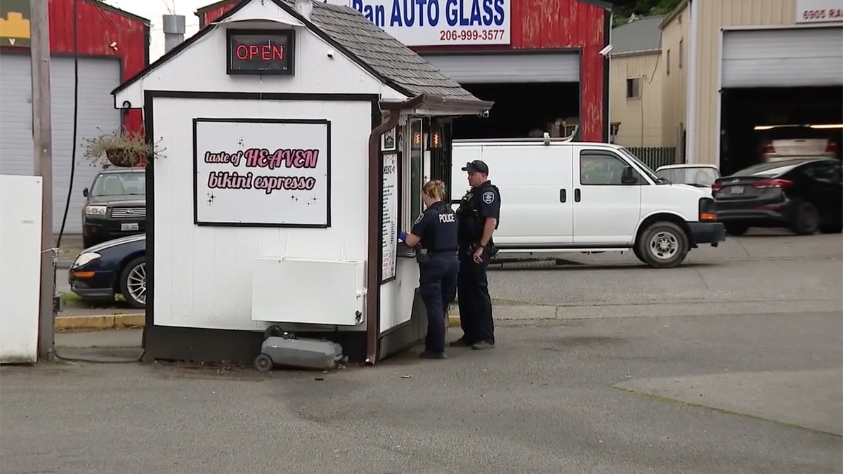 Bikini-clad barista takes hammer to customer’s windshield after he throws coffee at her